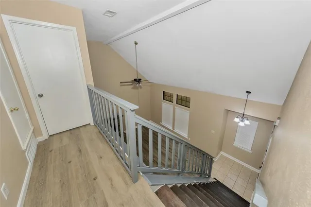 an empty room with closet and a ceiling fan