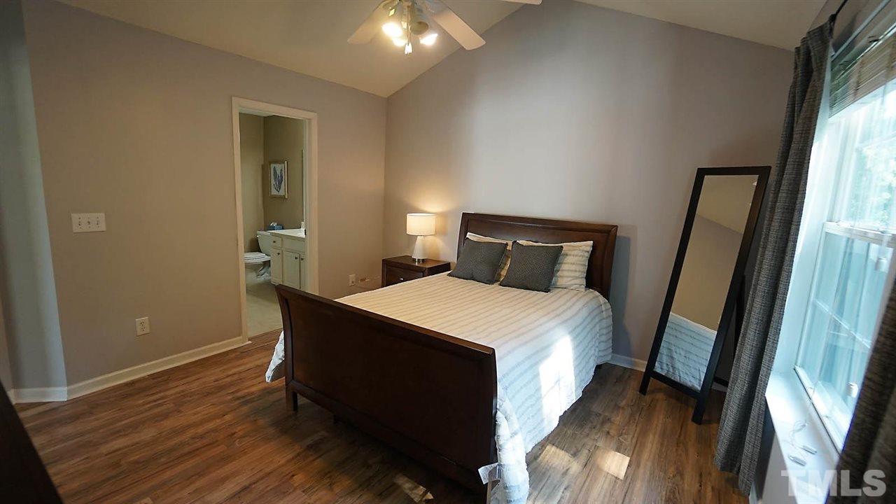 8900 Shallcross Way Raleigh, NC 27617 - Photo 11 of 22 a bedroom with a bed and a mirror