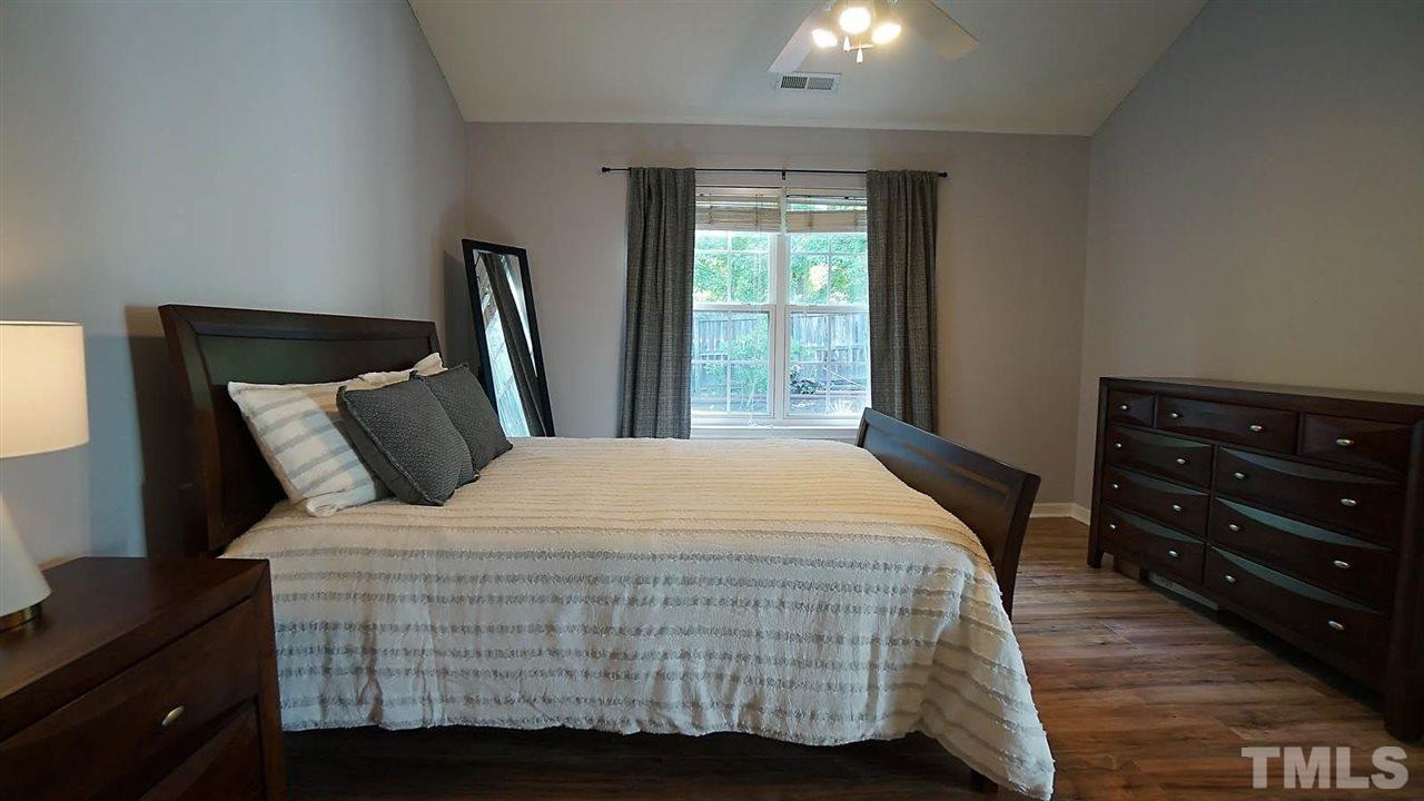 8900 Shallcross Way Raleigh, NC 27617 - Photo 12 of 22 a bedroom with a bed and a night stand