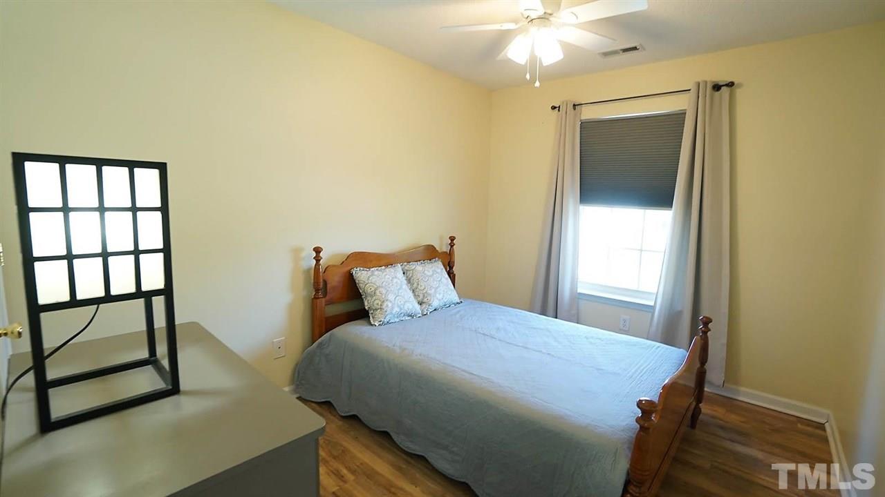 8900 Shallcross Way Raleigh, NC 27617 - Photo 15 of 22 a bedroom with a bed and a window