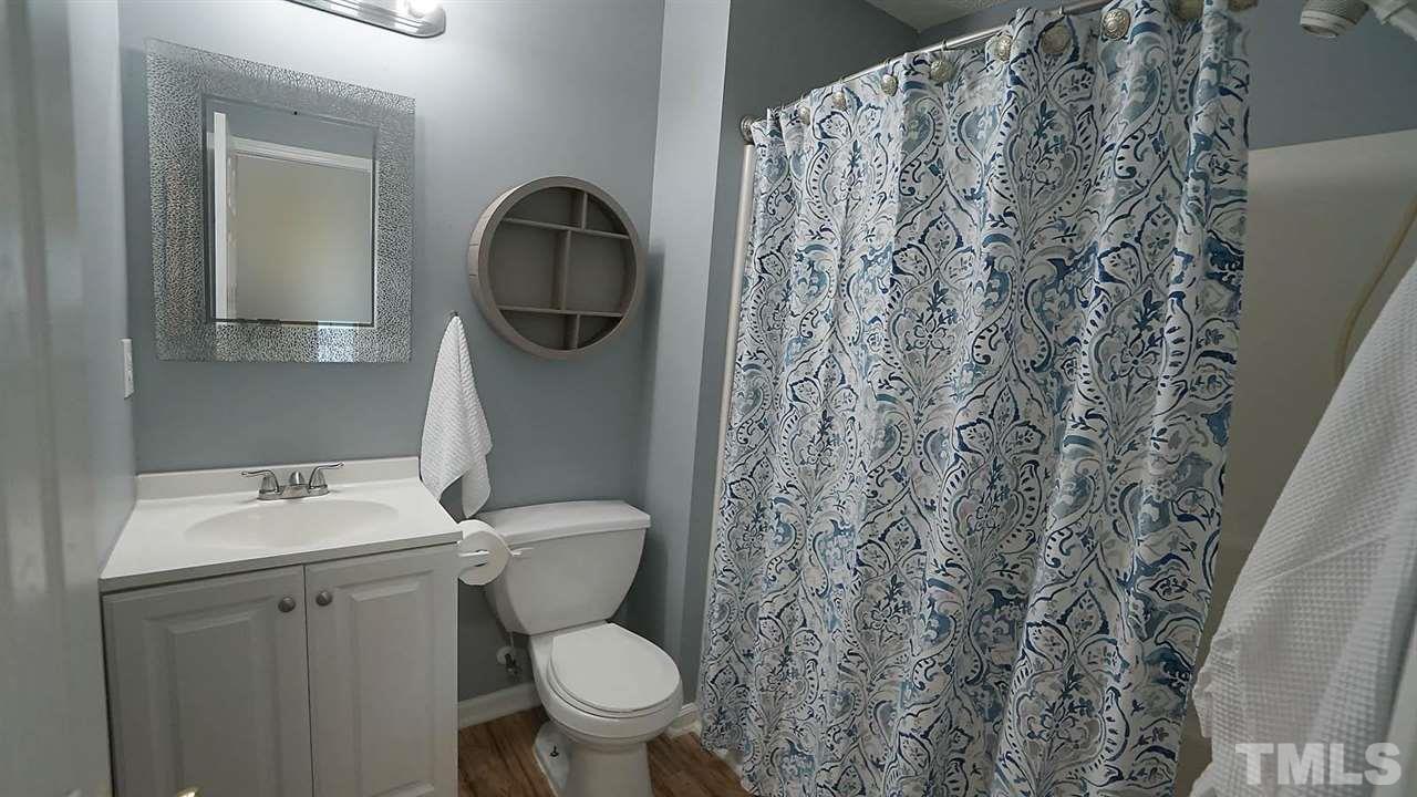 8900 Shallcross Way Raleigh, NC 27617 - Photo 16 of 22 a bathroom with a toilet sink and mirror