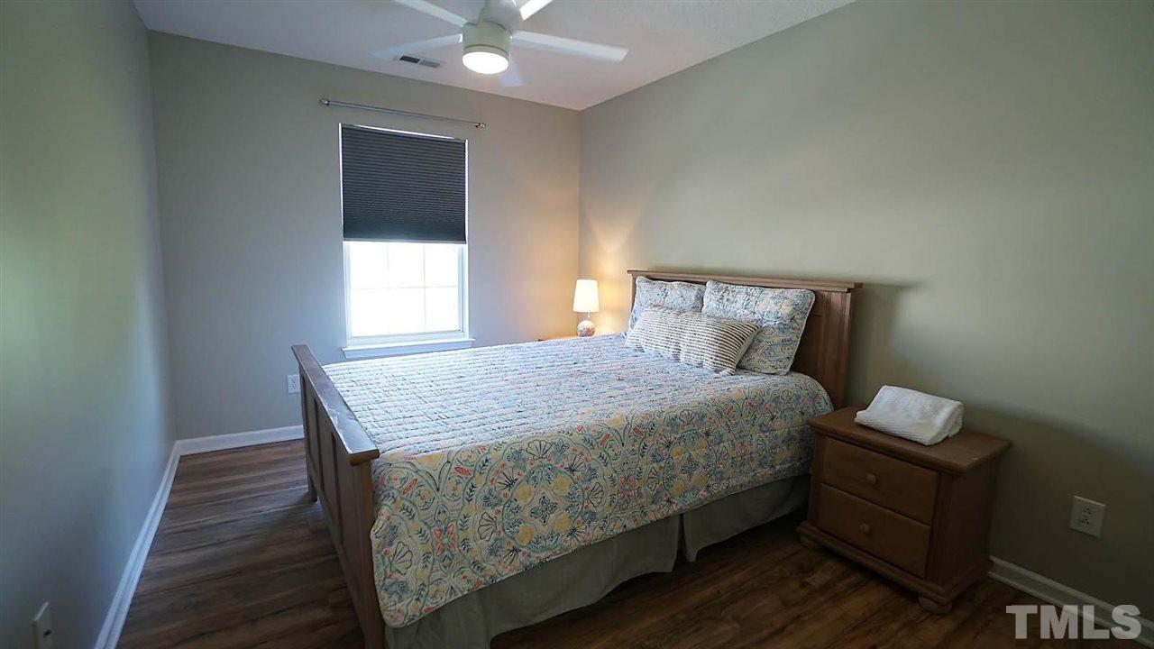 8900 Shallcross Way Raleigh, NC 27617 - Photo 17 of 22 a bed sitting in a bedroom next to a window