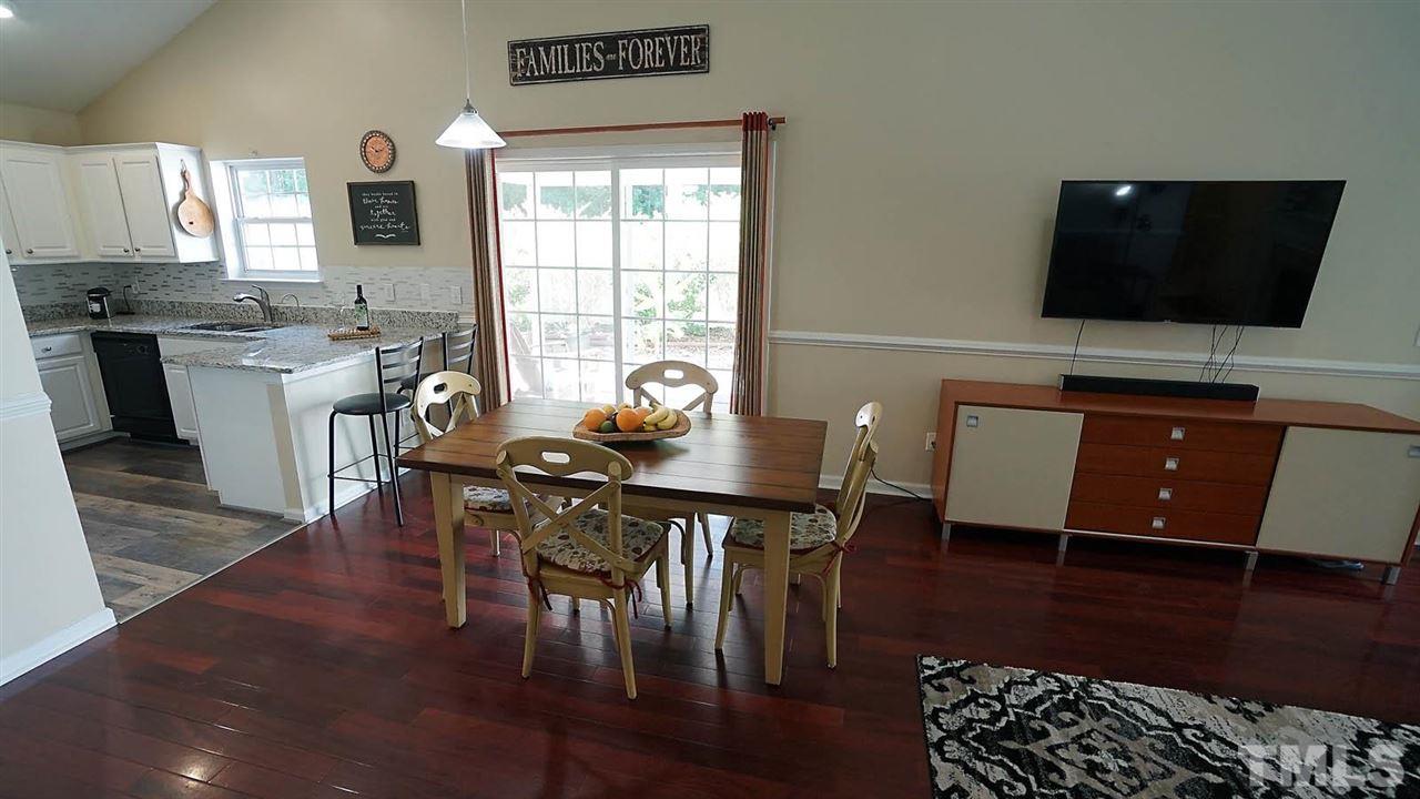8900 Shallcross Way Raleigh, NC 27617 - Photo 18 of 22 a living room with furniture and a flat screen tv