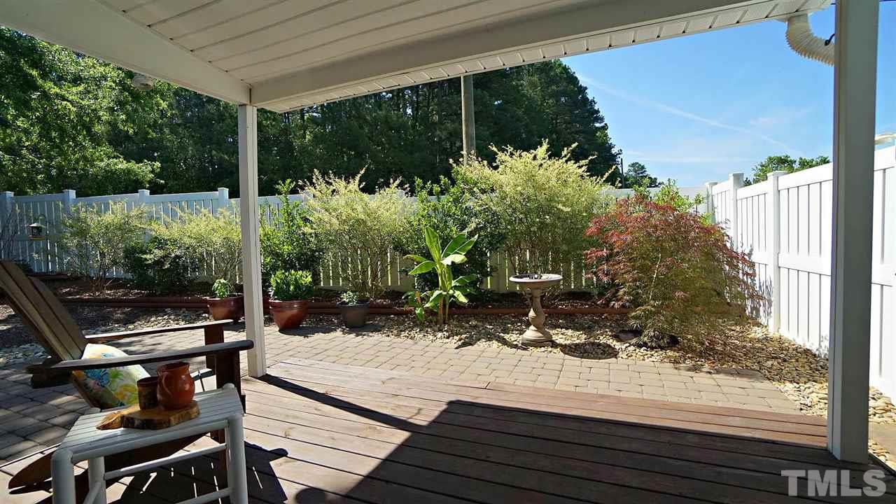 8900 Shallcross Way Raleigh, NC 27617 - Photo 20 of 22 a view of a balcony with chairs and wooden floor