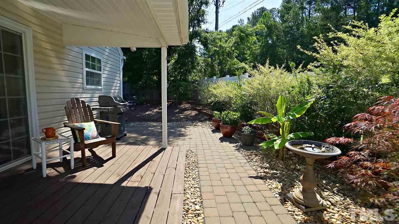 8900 Shallcross Way Raleigh, NC 27617 - Photo 21 of 22 a view of a porch with chairs and potted plants