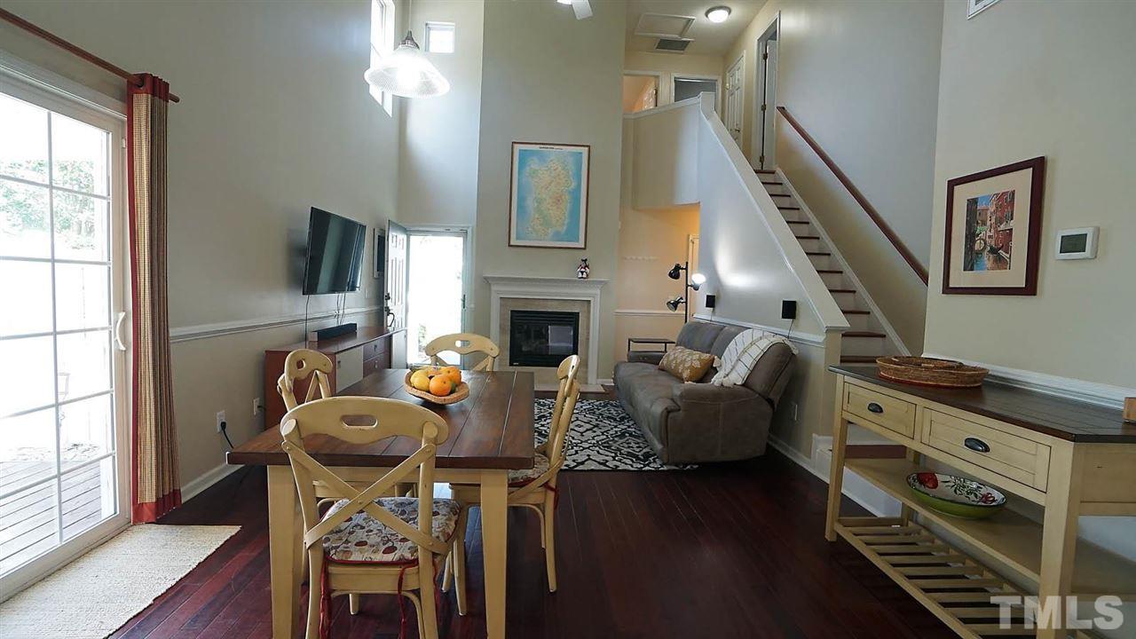 8900 Shallcross Way Raleigh, NC 27617 - Photo 5 of 22 a living room with furniture a fireplace and a flat screen tv