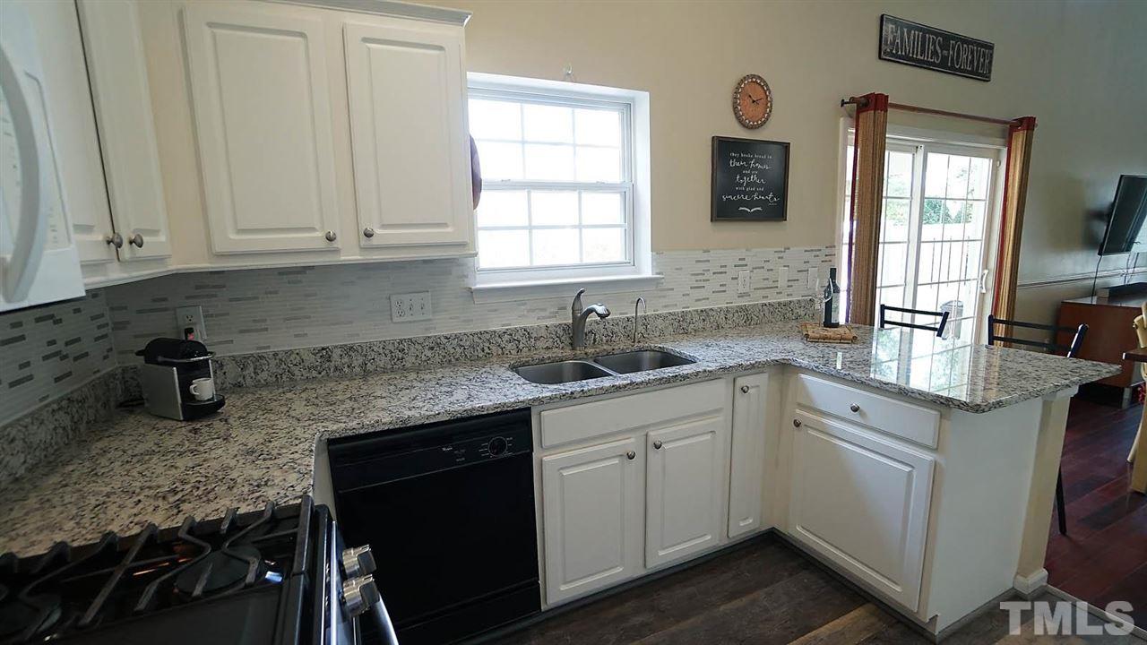 8900 Shallcross Way Raleigh, NC 27617 - Photo 10 of 22 a kitchen with sink cabinets and window