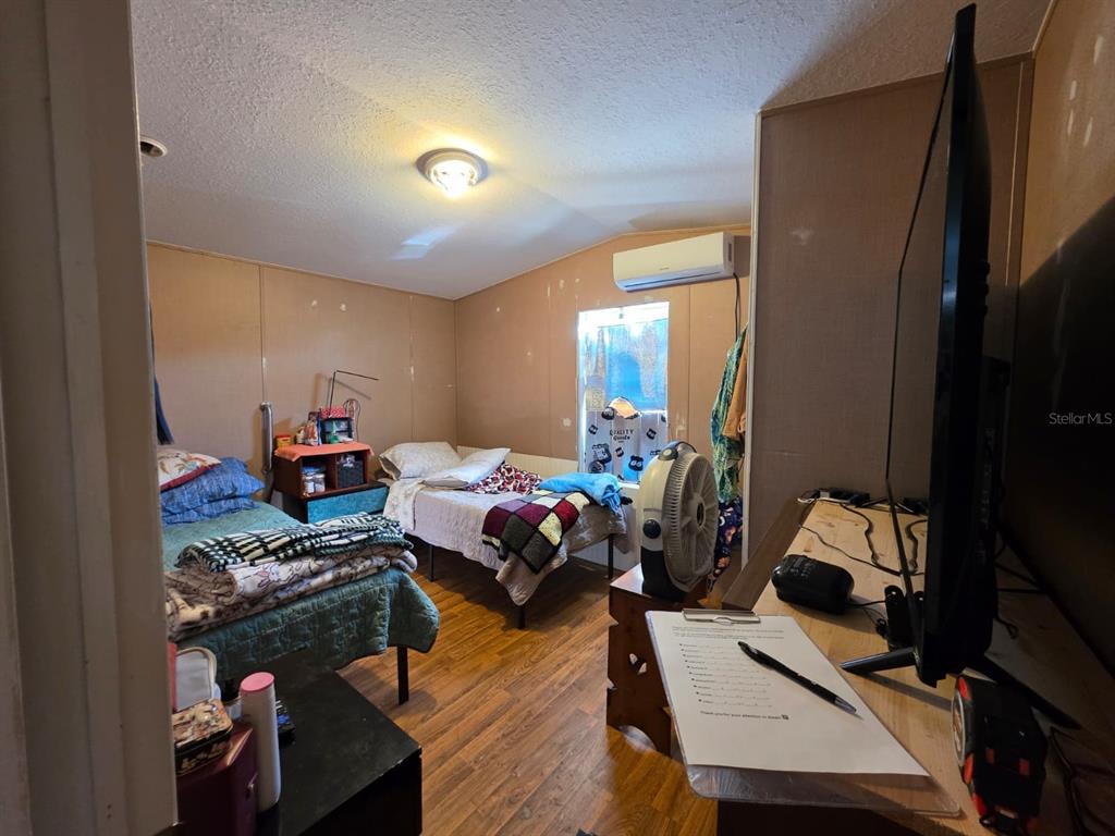 2000 Palm Street St. Cloud, FL 34769 - Photo 21 of 21 a bedroom with furniture and a wooden floor