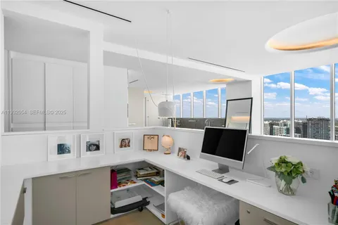 a work place with furniture and a potted plant