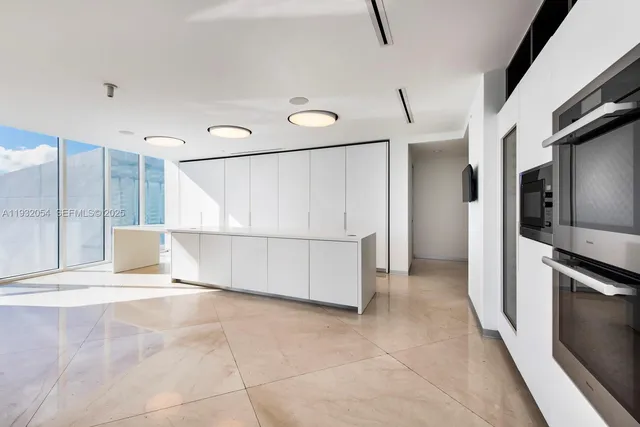 a view of a kitchen with a sink and stainless steel appliances