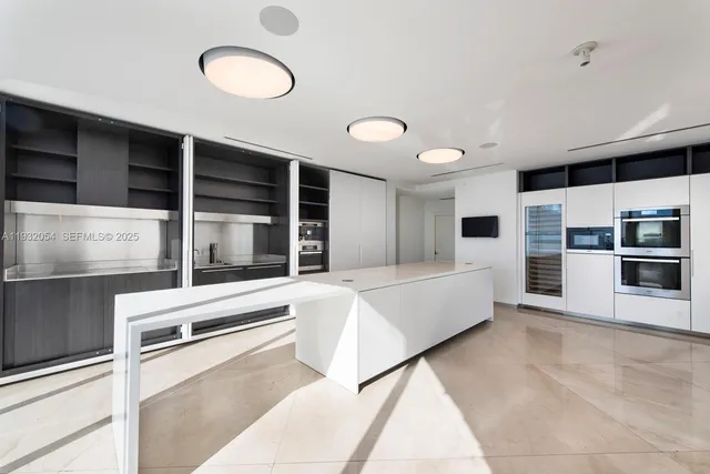 a living room with furniture and kitchen view