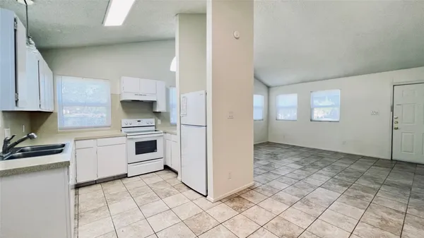 a kitchen with a stove a sink and a refrigerator