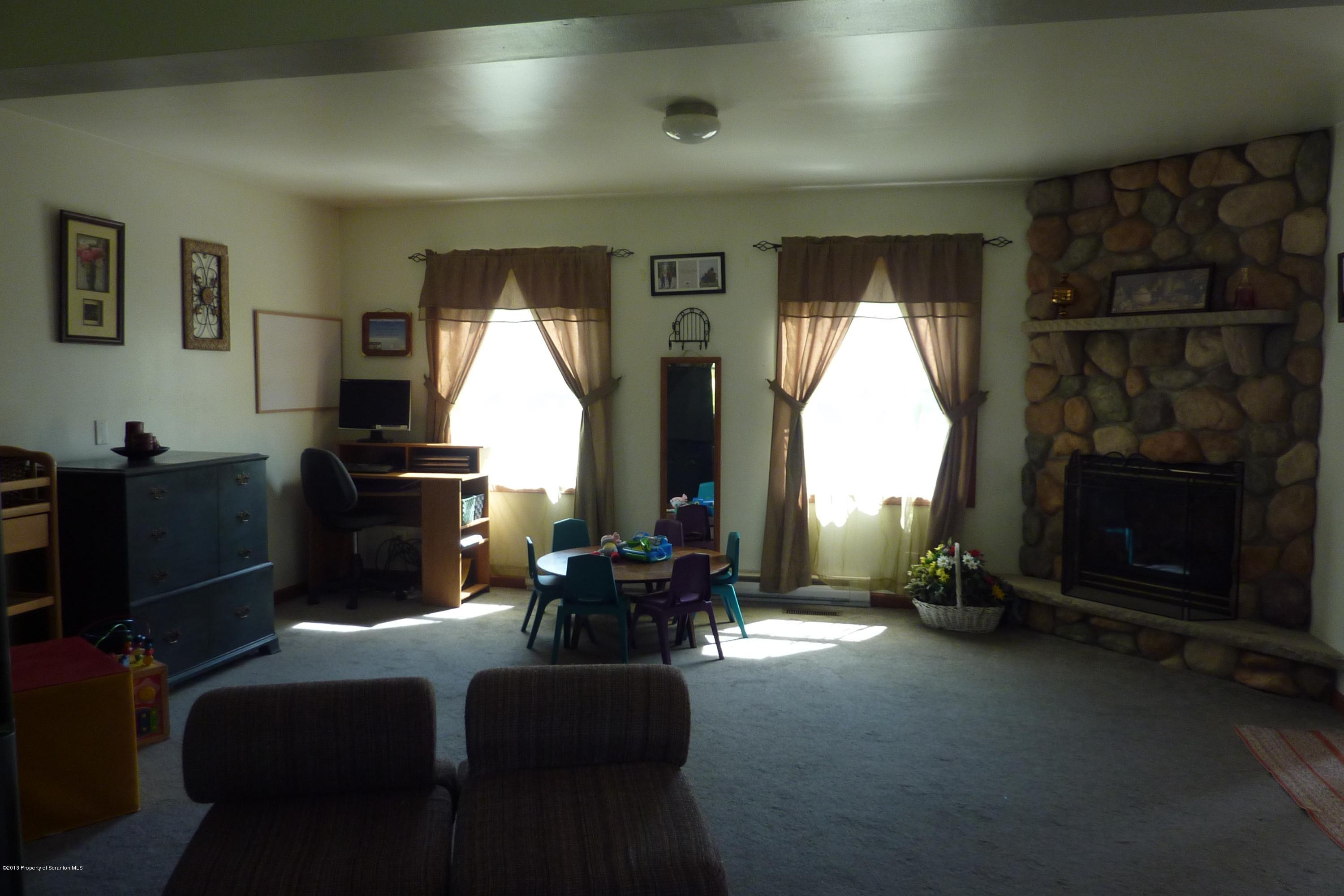 4110 Bear Brook Road Moscow, PA 18444 - Photo 11 of 31 a living room with furniture a fireplace and a flat screen tv