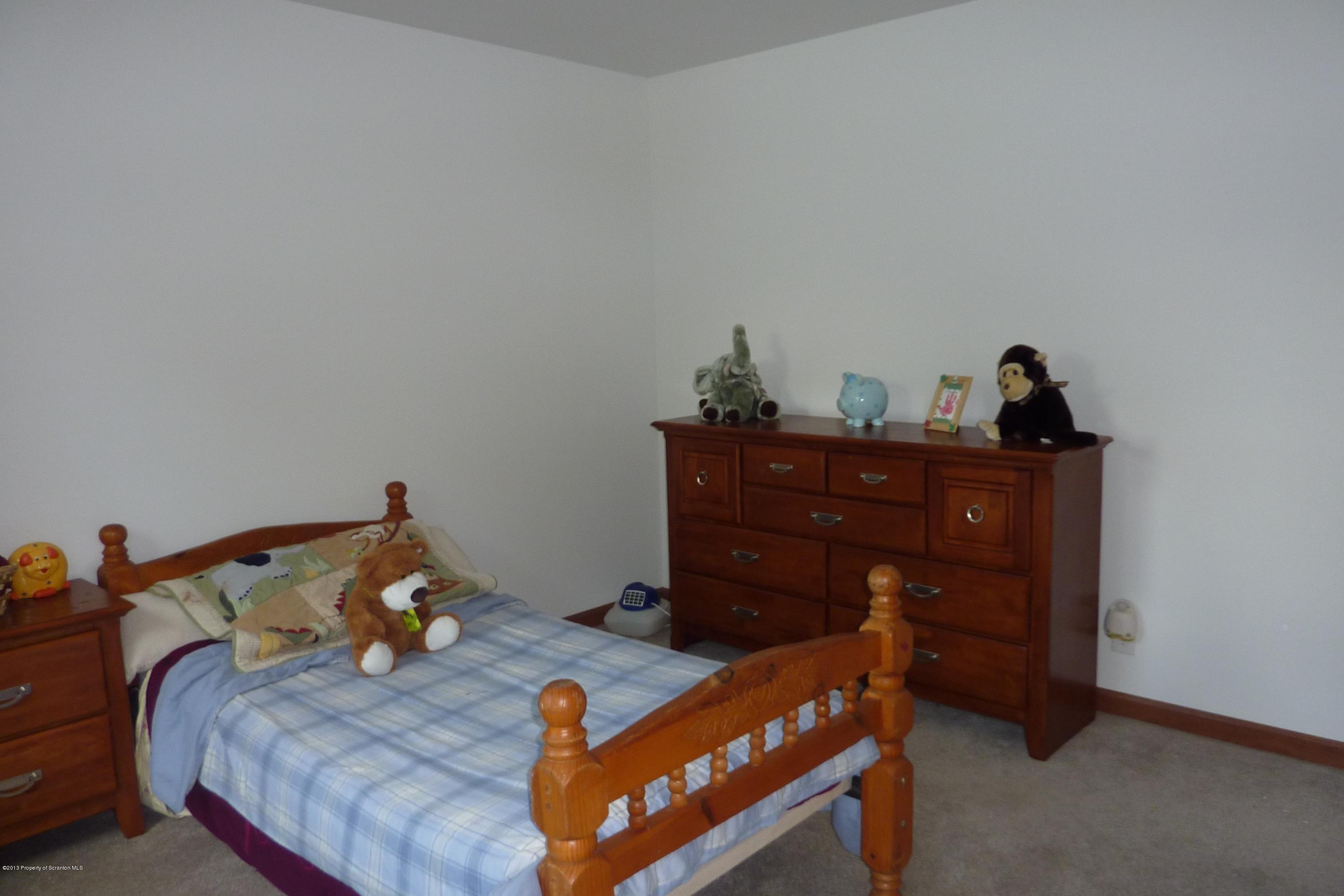 4110 Bear Brook Road Moscow, PA 18444 - Photo 18 of 31 a bed room with a bed and a dresser