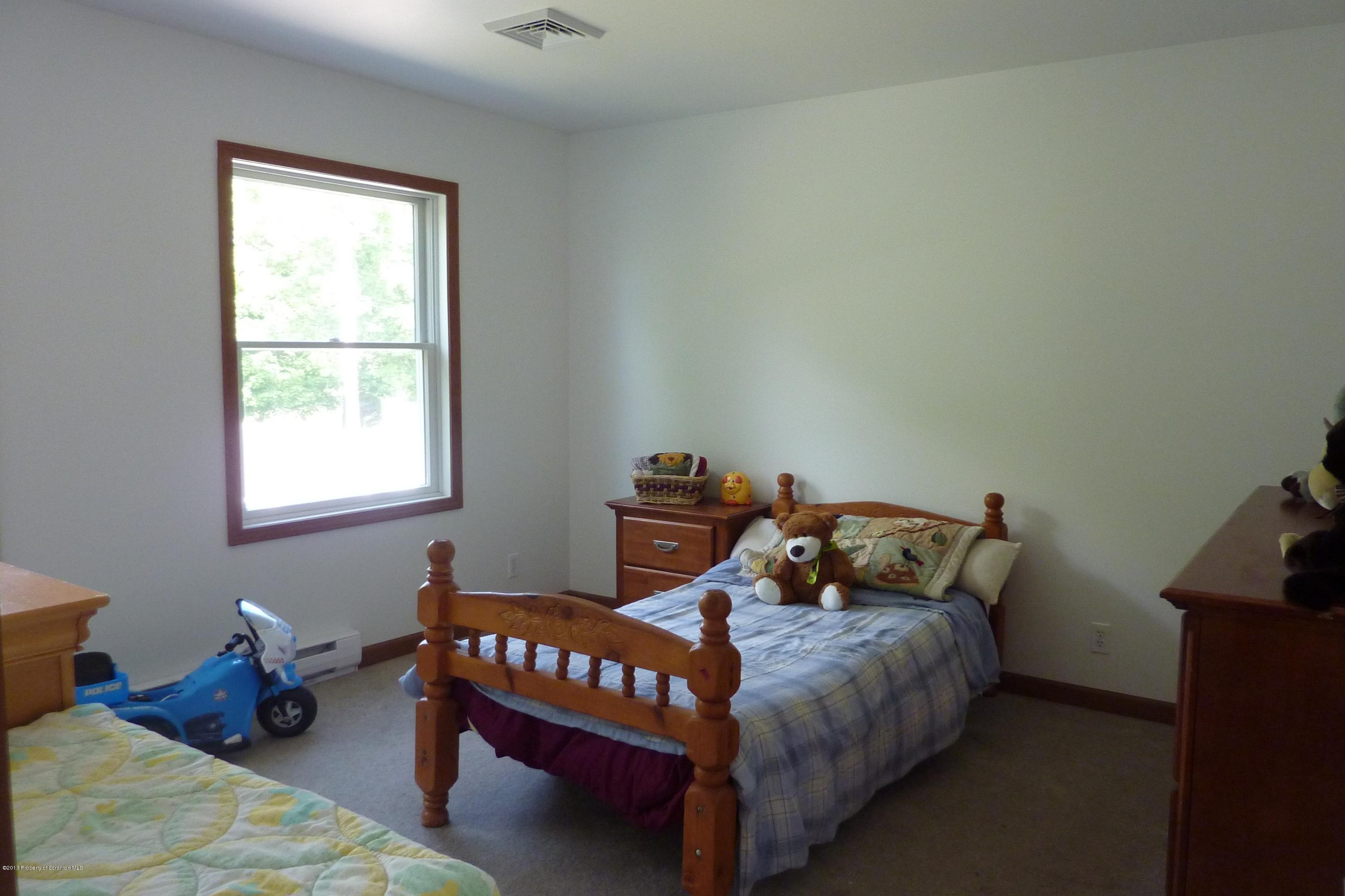 4110 Bear Brook Road Moscow, PA 18444 - Photo 19 of 31 a bedroom with a bed and a window