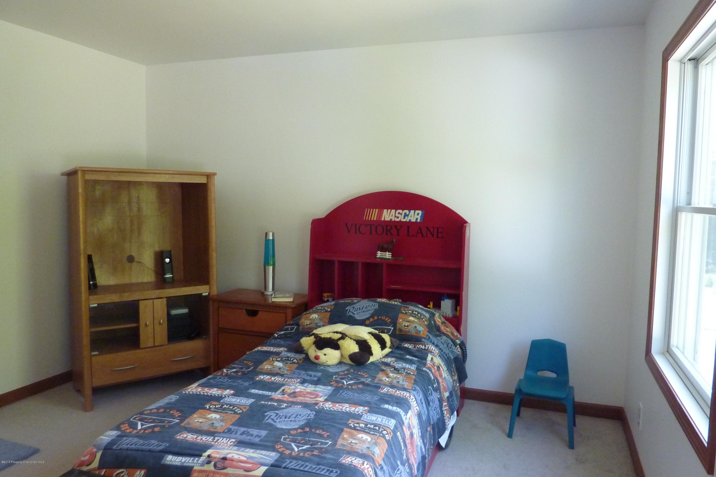 4110 Bear Brook Road Moscow, PA 18444 - Photo 20 of 31 a bedroom with a bed and a window