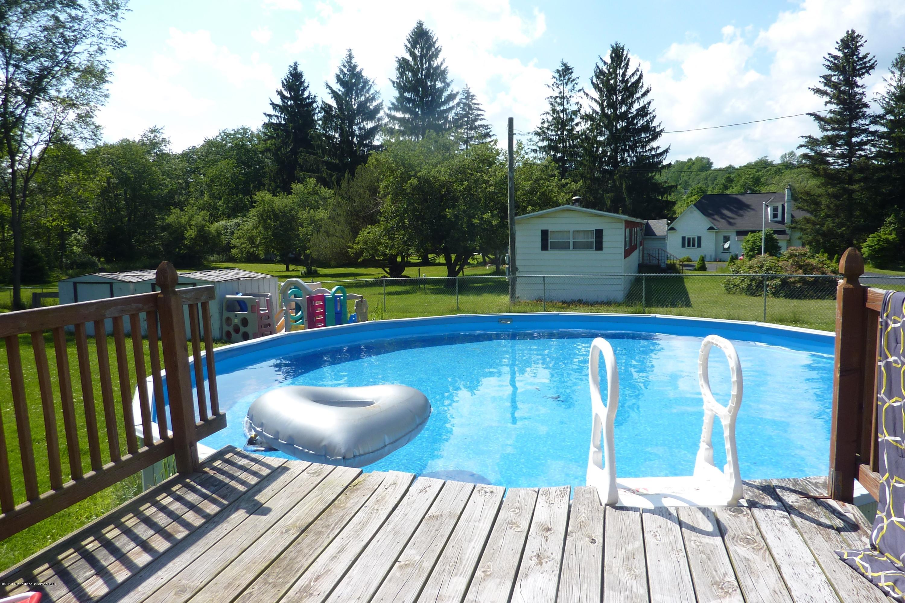 4110 Bear Brook Road Moscow, PA 18444 - Photo 25 of 31 a balcony with wooden floor and outdoor seating