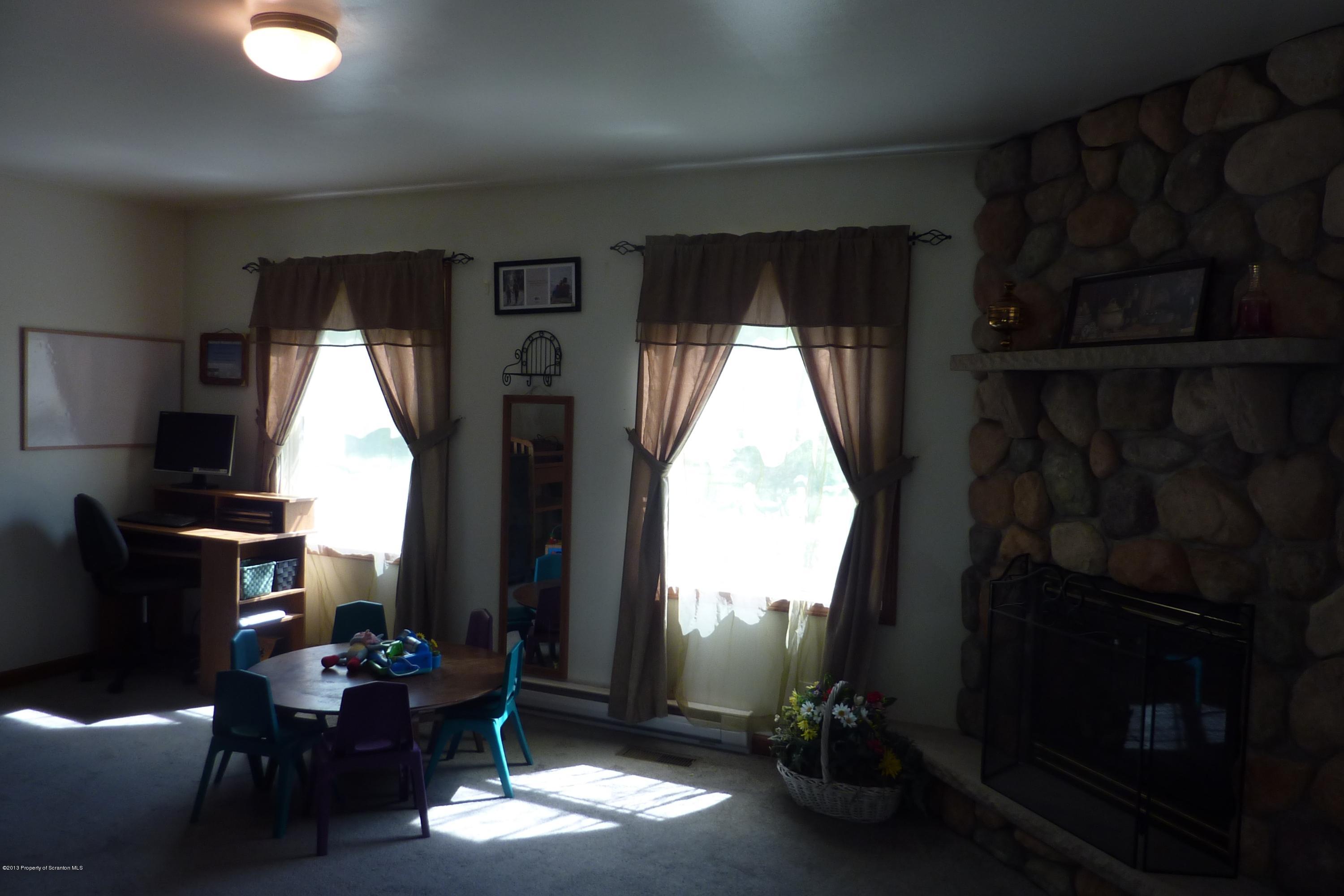 4110 Bear Brook Road Moscow, PA 18444 - Photo 9 of 31 a living room with furniture a window and a fireplace