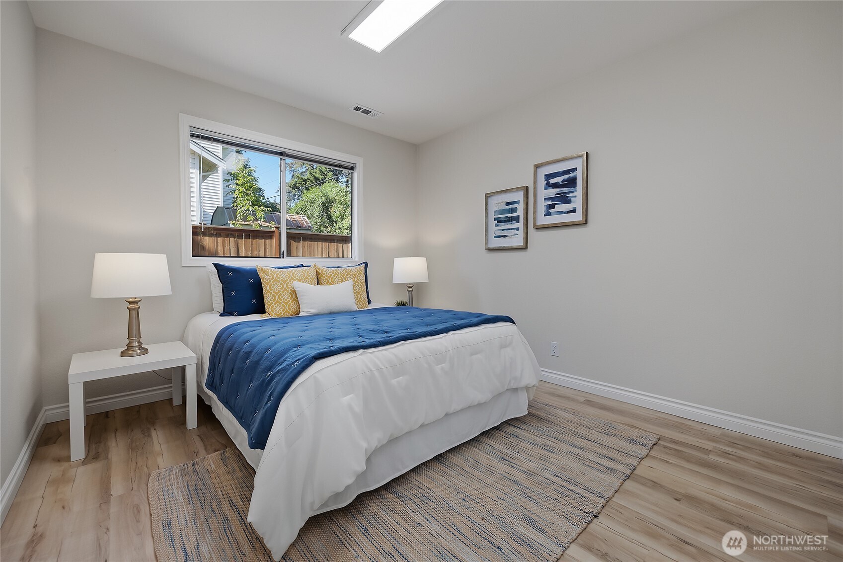 23707 Meridian Place West Bothell, WA 98021 - Photo 29 of 40 a bedroom with a bed a lamp and window