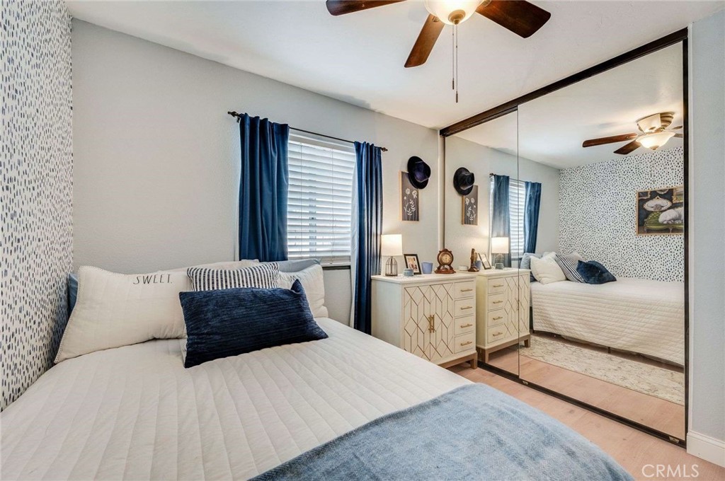 10744 Sundance Drive Rancho Cucamonga, CA 91730 - Photo 15 of 27 a bedroom with a large bed and a chandelier