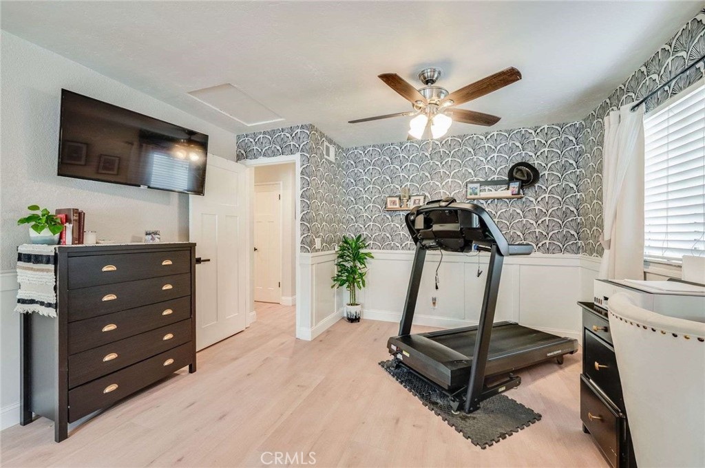 10744 Sundance Drive Rancho Cucamonga, CA 91730 - Photo 19 of 27 a room with gym equipment and a flat screen tv