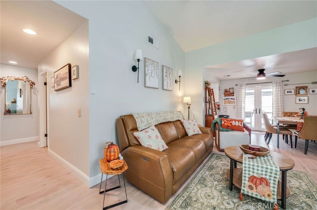 10744 Sundance Drive Rancho Cucamonga, CA 91730 - Photo 3 of 27 a living room with furniture and a dining table with wooden floor