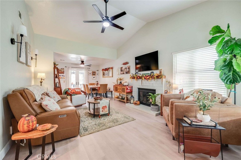 10744 Sundance Drive Rancho Cucamonga, CA 91730 - Photo 4 of 27 a living room with furniture flat screen tv and a fireplace