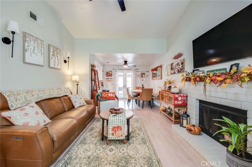 10744 Sundance Drive Rancho Cucamonga, CA 91730 - Photo 5 of 27 a living room with furniture a flat screen tv and a fireplace