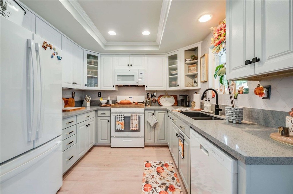 10744 Sundance Drive Rancho Cucamonga, CA 91730 - Photo 8 of 27 a kitchen with stainless steel appliances a sink a stove a refrigerator and cabinets