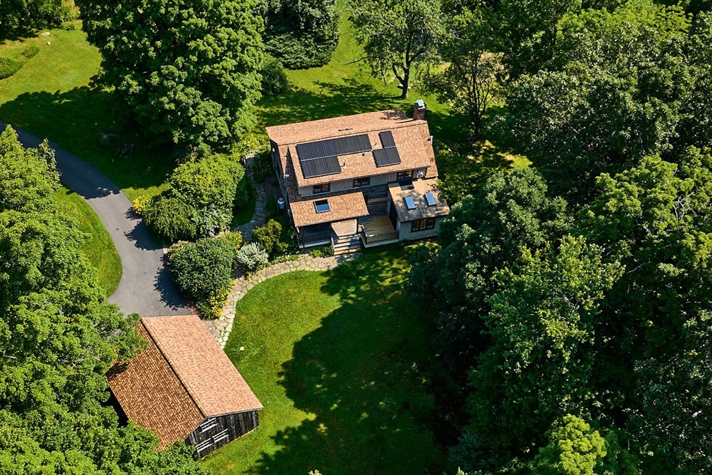 63 Montague Road Leverett, MA 01054 - Photo 1 of 42 an aerial view of a house with garden space and street view