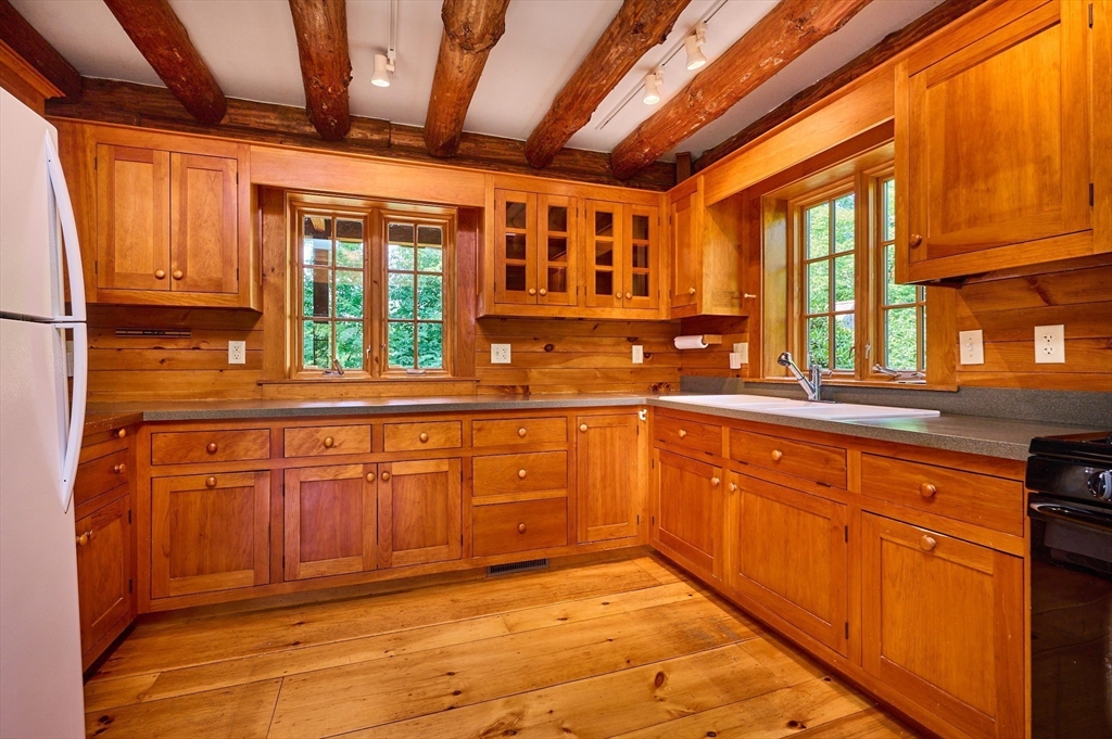 63 Montague Road Leverett, MA 01054 - Photo 12 of 42 a large kitchen with stainless steel appliances granite countertop a sink and cabinets