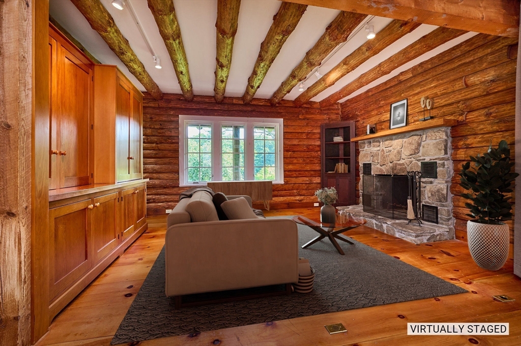 63 Montague Road Leverett, MA 01054 - Photo 15 of 42 a living room with furniture a large window and wooden floor