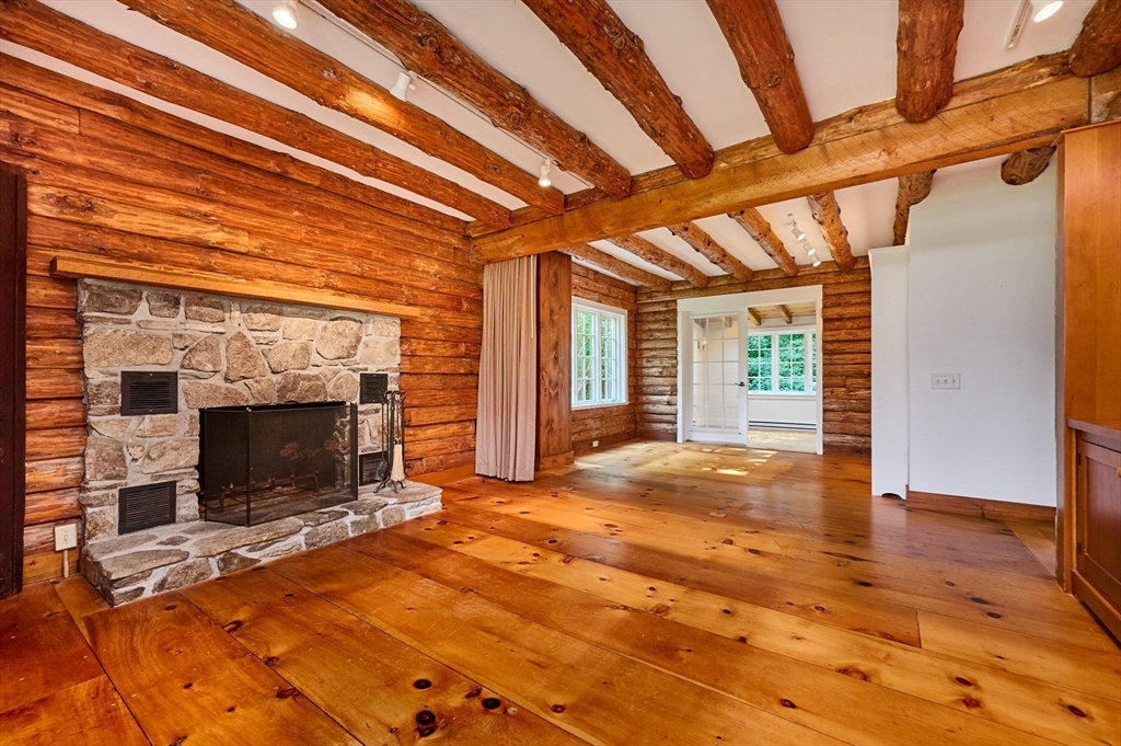 63 Montague Road Leverett, MA 01054 - Photo 16 of 42 a view of empty room with wooden floor and fireplace