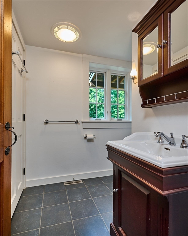 63 Montague Road Leverett, MA 01054 - Photo 20 of 42 a bathroom with a sink a toilet and a window