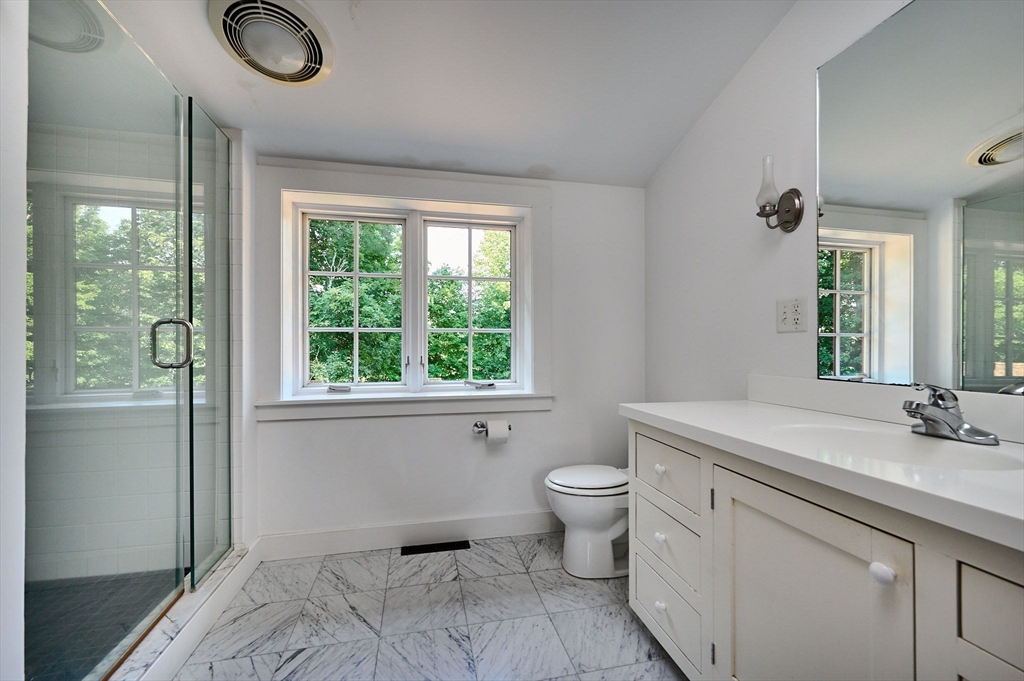 63 Montague Road Leverett, MA 01054 - Photo 28 of 42 a spacious bathroom with a granite countertop toilet sink and mirror