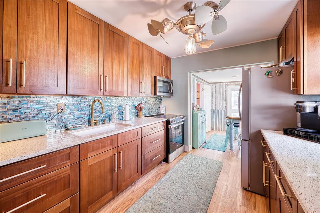 1027 Coral Ridge Drive Punta Gorda, FL 33950 - Photo 11 of 46 a kitchen with stainless steel appliances granite countertop a sink stove and refrigerator