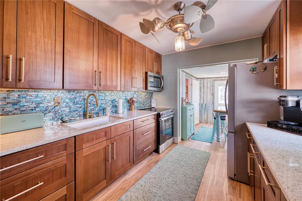1027 Coral Ridge Drive Punta Gorda, FL 33950 - Photo 12 of 46 a kitchen with stainless steel appliances granite countertop a sink stove and refrigerator