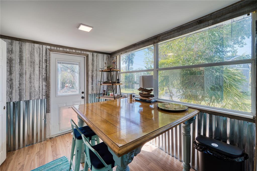 1027 Coral Ridge Drive Punta Gorda, FL 33950 - Photo 13 of 46 a view of a dining room and livingroom with furniture window and wooden floor