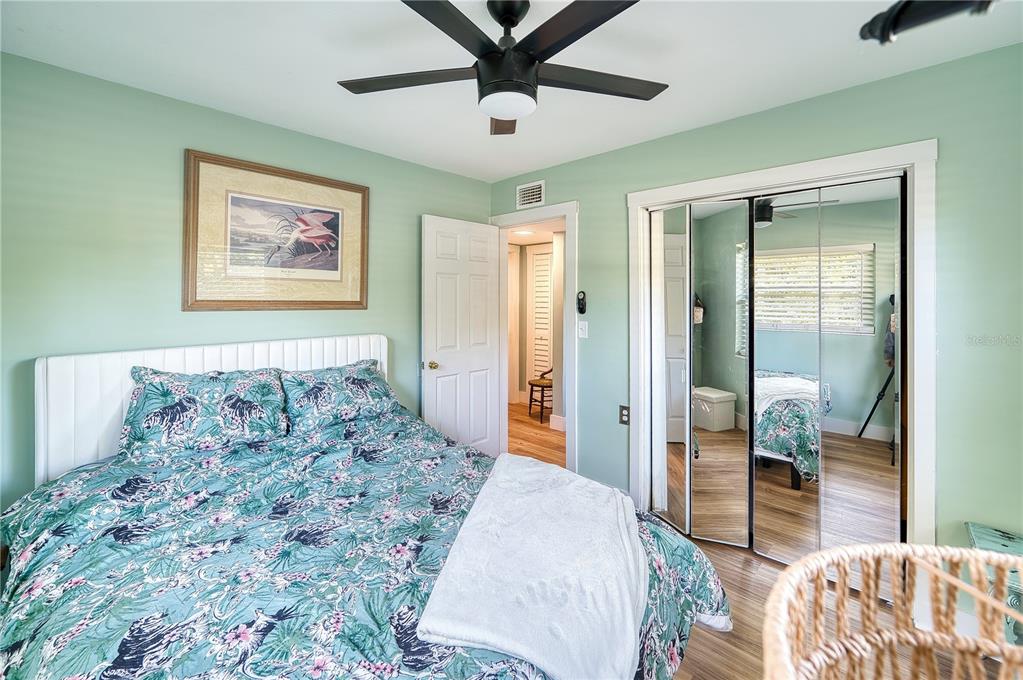 1027 Coral Ridge Drive Punta Gorda, FL 33950 - Photo 15 of 46 a bedroom with a large bed and a chandelier