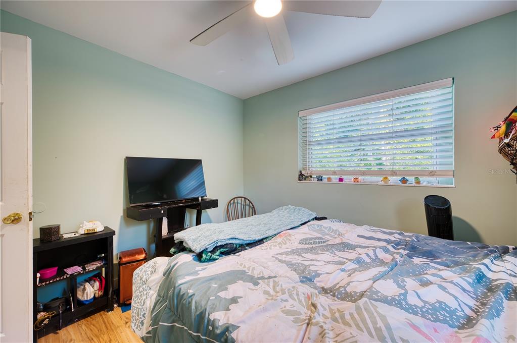 1027 Coral Ridge Drive Punta Gorda, FL 33950 - Photo 19 of 46 a bedroom with a bed and a flat screen tv