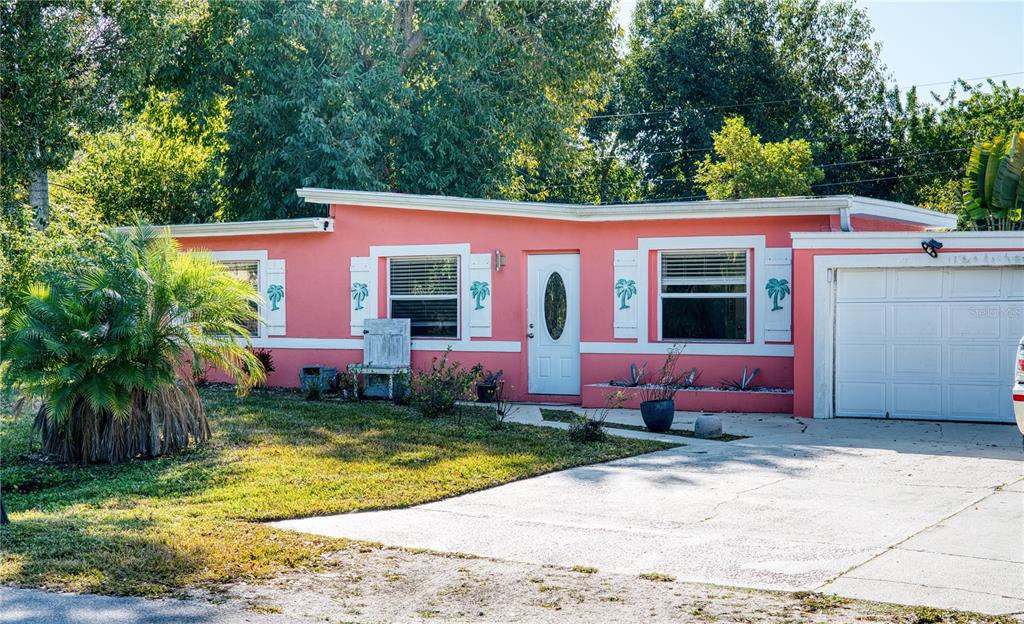 1027 Coral Ridge Drive Punta Gorda, FL 33950 - Photo 2 of 46 a front view of a house with a yard