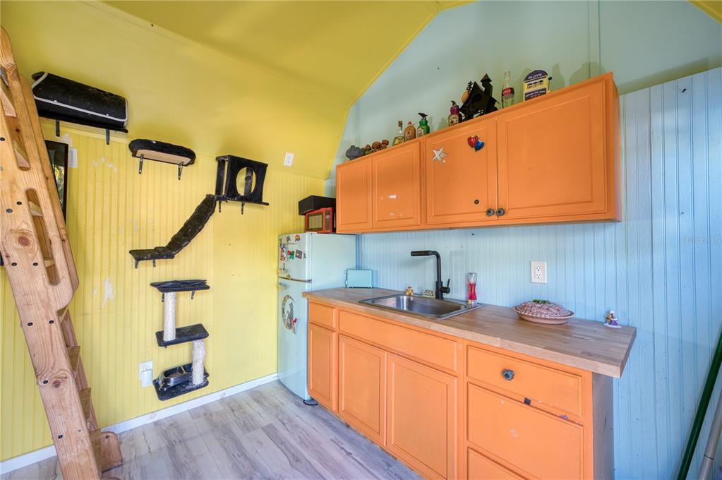 1027 Coral Ridge Drive Punta Gorda, FL 33950 - Photo 25 of 46 a kitchen with a sink a refrigerator and cabinets