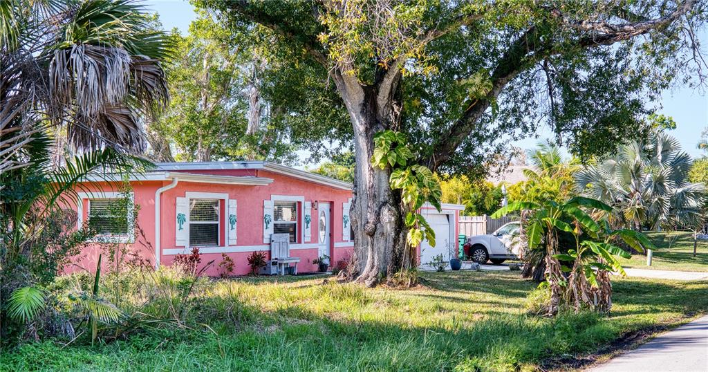 1027 Coral Ridge Drive Punta Gorda, FL 33950 - Photo 3 of 46 a front view of a house with swimming pool and garden