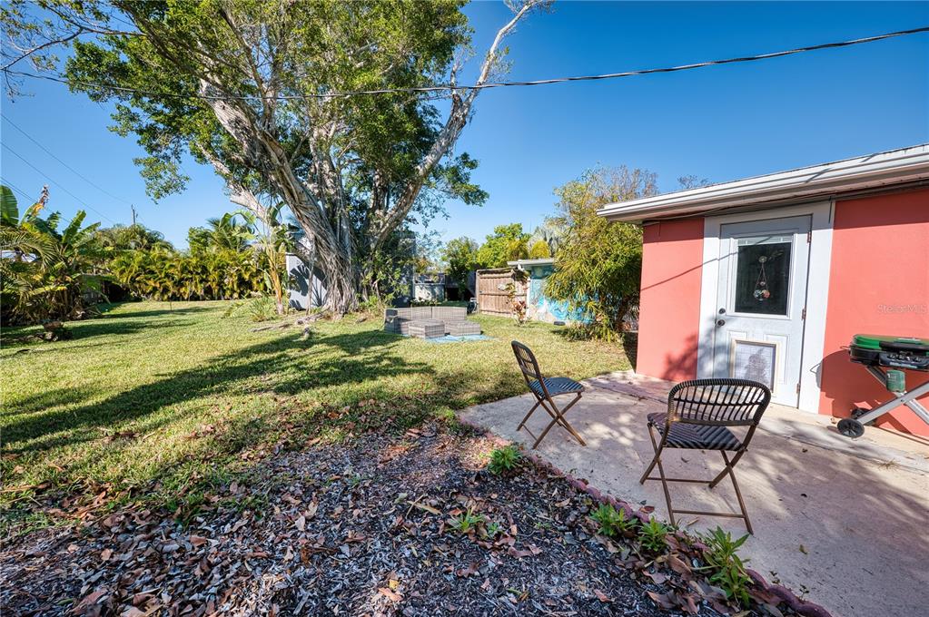 1027 Coral Ridge Drive Punta Gorda, FL 33950 - Photo 31 of 46 a backyard of a house with a yard and outdoor seating