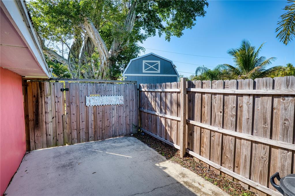 1027 Coral Ridge Drive Punta Gorda, FL 33950 - Photo 34 of 46 a view of wooden fence and a couple of potted plants