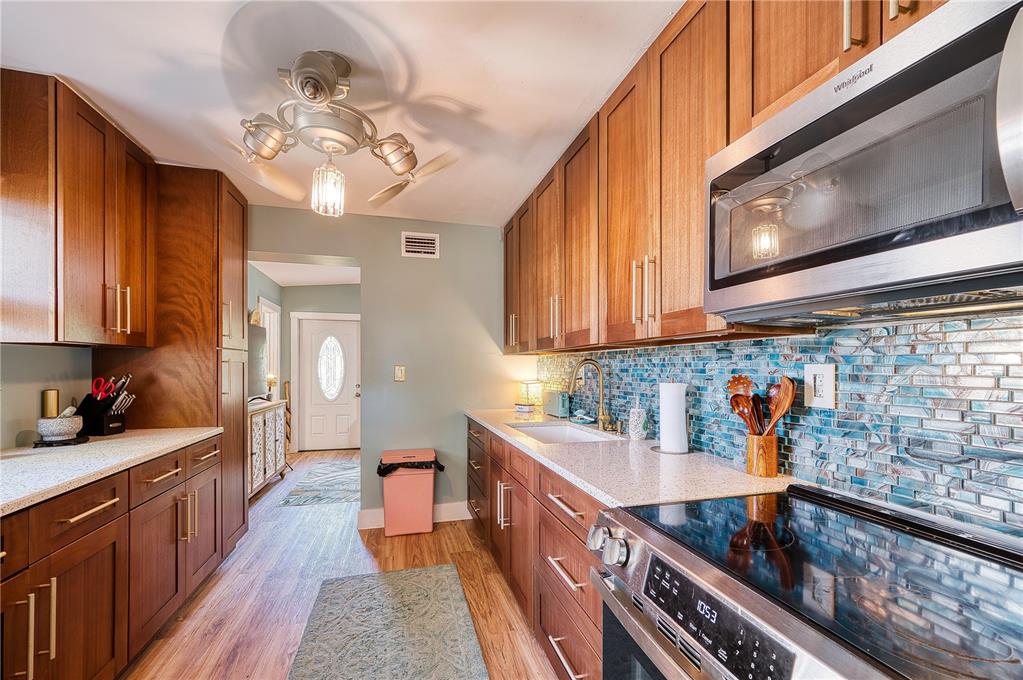 1027 Coral Ridge Drive Punta Gorda, FL 33950 - Photo 10 of 46 a kitchen with stainless steel appliances a sink stove and cabinets