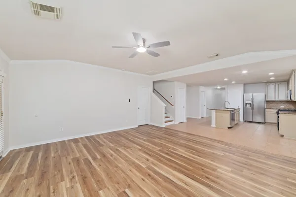 a view of empty room with wooden floor and fireplace