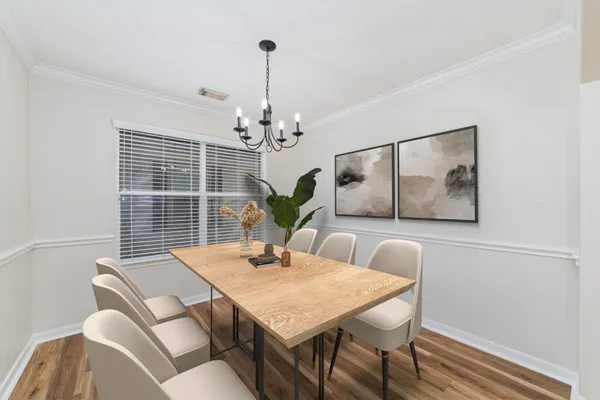 a view of a dining room with furniture wooden floor and chandelier