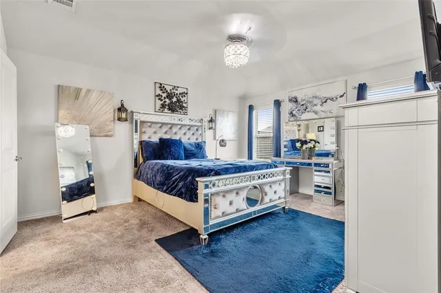 a bedroom with bed and a chandelier