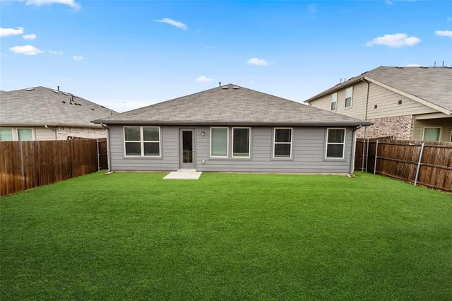 a front view of a house with yard and green space